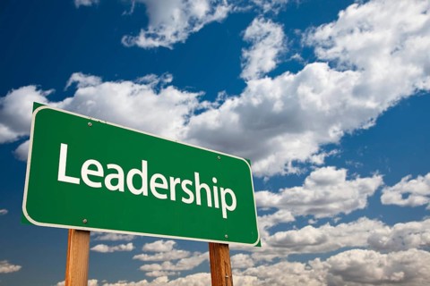 Leadership green road sign with copy room over the dramatic clouds and sky