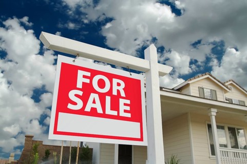 Home for sale sign in front of new house
