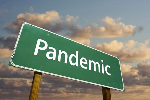Pandemic green road sign with dramatic clouds and sky