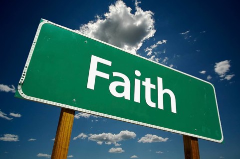 Faith road sign with dramatic clouds and sky