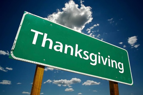 Thanksgiving green road sign with dramatic clouds and sky
