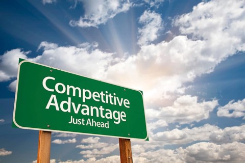 Competitive advantage green road sign with dramatic clouds and sky