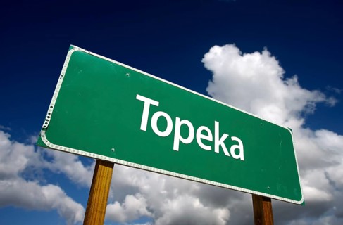 Topeka road sign with dramatic blue sky and clouds
