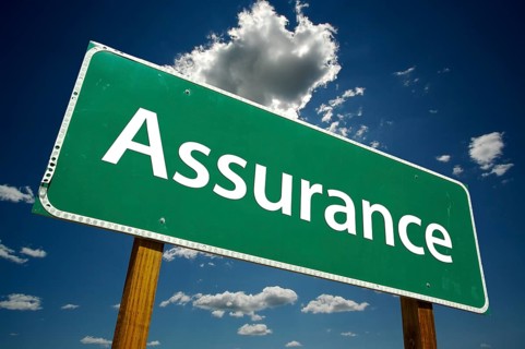 Assurance road sign with dramatic clouds and sky