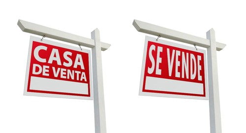 Two spanish house for sale real estate signs with clipping paths isolated on a white background