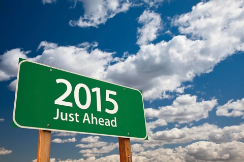 2015 just ahead green road sign over dramatic clouds and sky