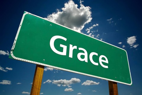 Grace green road sign with dramatic clouds and sky