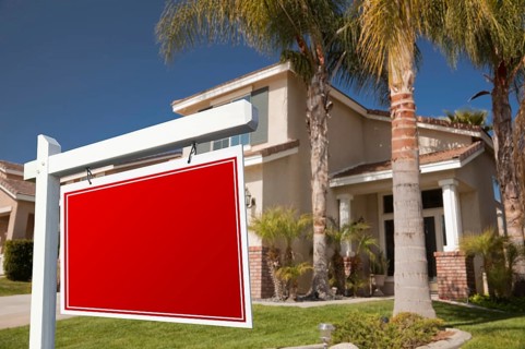 Blank real estate sign in front of house