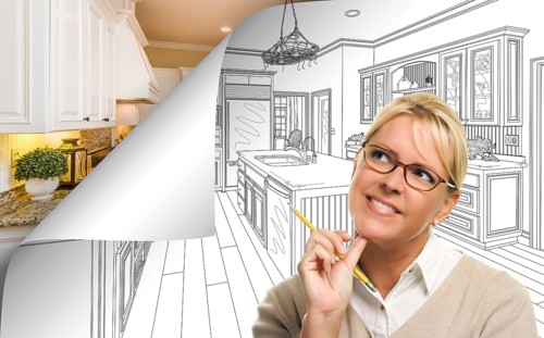 Woman facing kitchen drawing page corner flipping with photo behind