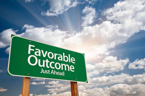 Favorable outcome green road sign with dramatic clouds and sky