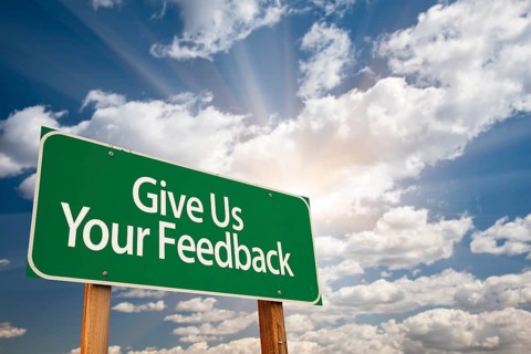 Give us your feedback green road sign with dramatic clouds and sky