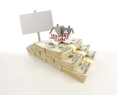 Stacks of one hundred dollar bills with small house and blank sign on slight gradation