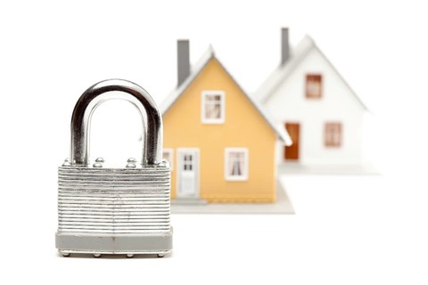 Lock and houses isolated on a white background