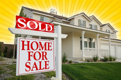 Sold home for sale sign with yellow star-burst background