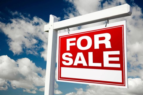 For sale real estate sign on clouds & sky background