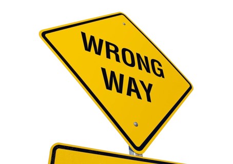 Yellow wrong way road sign isolated on a white background with clipping path