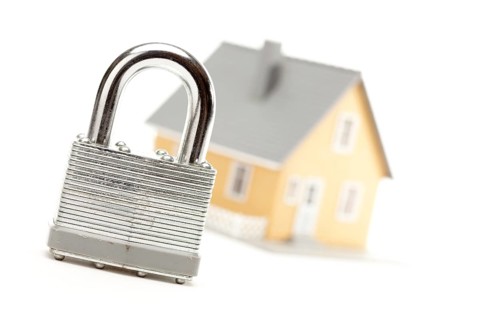 Lock and house isolated on a white background