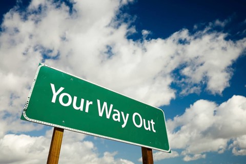 Your way out road sign with dramatic clouds and sky