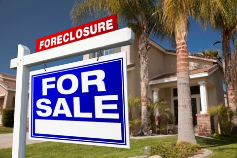 Foreclosure for sale real estate sign in front of house