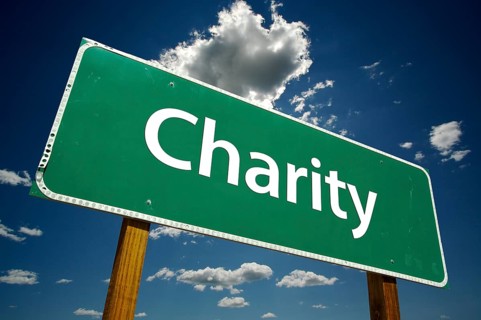 Charity road sign with dramatic blue sky and clouds