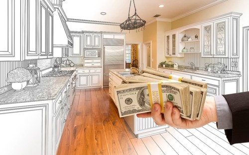 Hand handing stacks of money over custom kitchen design drawing and photo combination