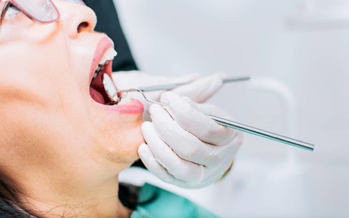 Dentist checking patient's mouth