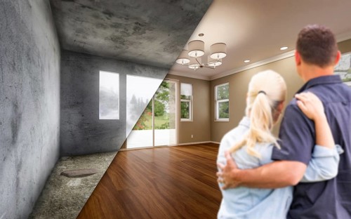 Young adult couple looking at before and after remodelling of empty room in house