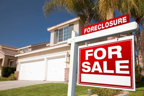 Foreclosure for sale real estate sign in front of house