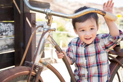 Cute mixed-race young boy having fun on the bicycle