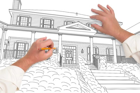 Male hands sketching with pencil the outline of a beautiful house on white