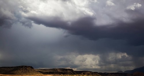 Ominous stormy skies with cumulous clouds and rain