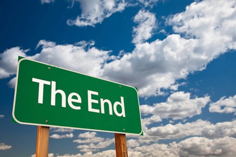 The end green road sign with copy room over the dramatic clouds and sky