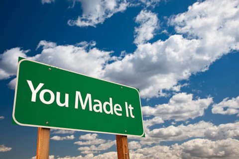 You made it green road sign with dramatic clouds and sky