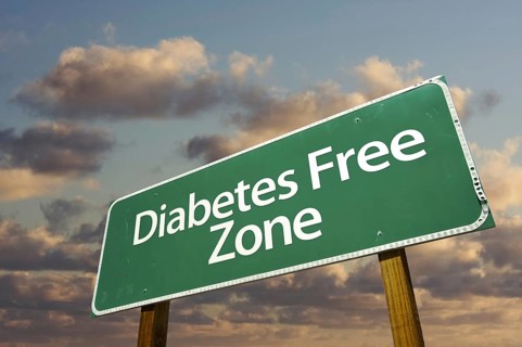 Diabetes free zone green road sign in front of dramatic clouds and sky