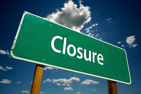 Closure road sign with dramatic clouds and sky
