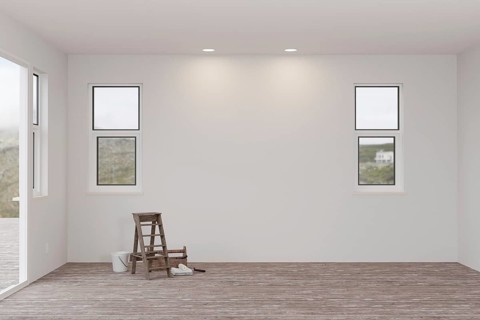 Ladder and painting equipment in raw unfinished room of house with blank white walls and worn wood floors