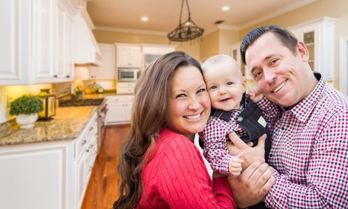 Young happy family inside beautiful custom kitchen