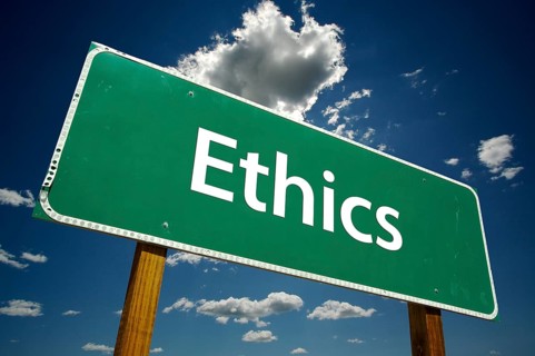 Ethics green road sign with dramatic blue sky and clouds