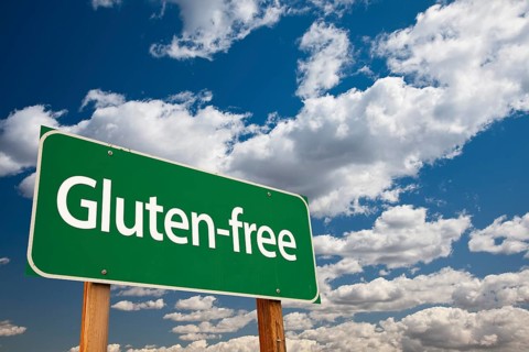 Gluten-free green road sign over dramatic blue sky and clouds