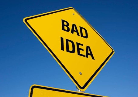 Yellow bad idea road sign against A deep blue sky with clipping path