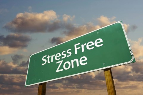 Stress free zone green road sign in front of dramatic clouds and sky