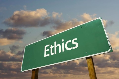 Ethics green road sign with dramatic blue sky and clouds
