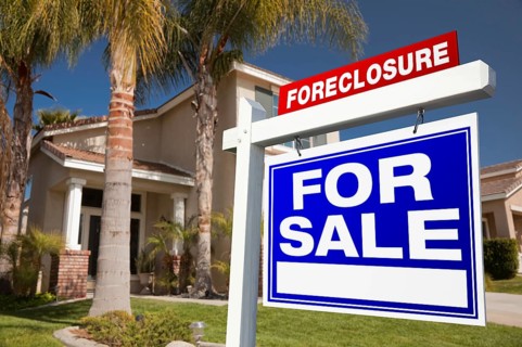 Foreclosure for sale real estate sign in front of house