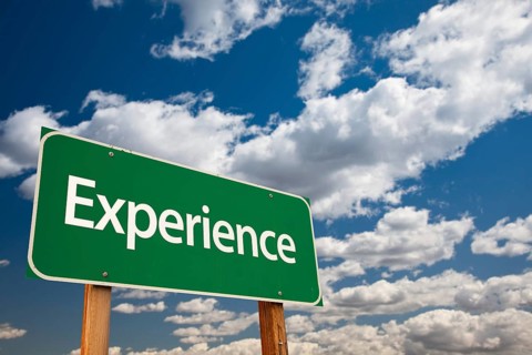 Experience green road sign with copy room over the dramatic clouds and sky
