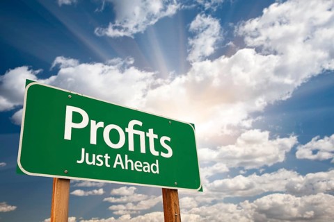 Profits green road sign with dramatic clouds and sky