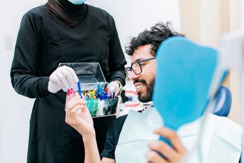 Patient with dentist choosing dental braces