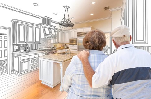 Senior couple looking over custom kitchen design drawing and photo combination