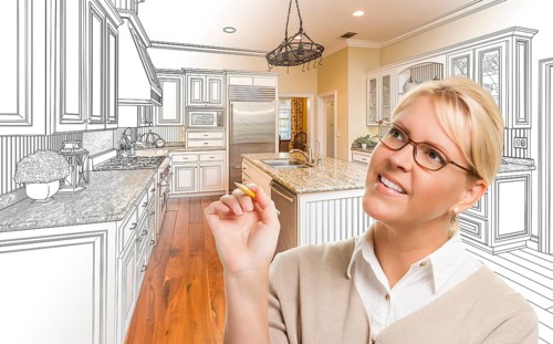 Creative woman with pencil over custom kitchen design drawing and photo combination