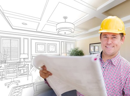 Smiling contractor in hard hat with roll of plans over custom bedroom drawing and photo combination