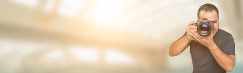 Hispanic man with DSLR camera wide banner with room for copy